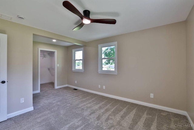711 S Main St, Monroe, OH 45050 - unfurnished bedroom with carpet flooring, a spacious closet, a ceiling fan, and a closet