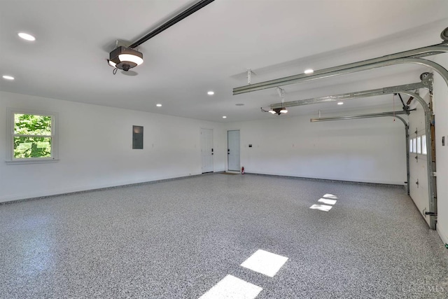 711 S Main St, Monroe, OH 45050 - garage with electric panel, a garage door opener, and recessed lighting