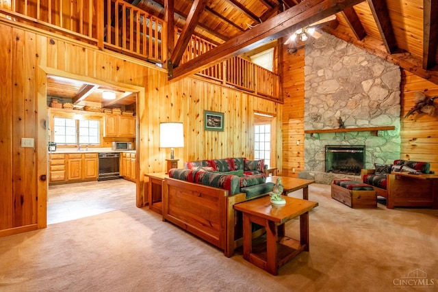 2914 Pond Run Ln, Pierce Twp, OH 45157 - living area with a wood ceiling with exposed beams, light colored carpet, wooden walls, a fireplace, and ceiling fan