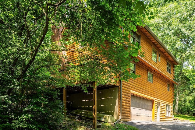 2914 Pond Run Ln, Pierce Twp, OH 45157 - view of home's exterior with a garage, a wooden deck, and driveway