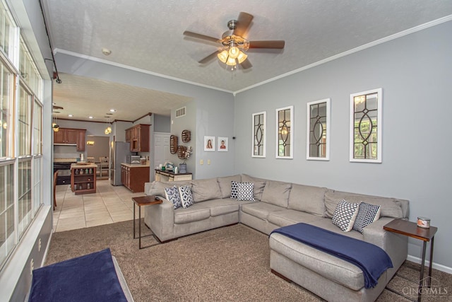 1887 Bantas Creek Rd, Washington Twp, OH 45320 - living room featuring ceiling fan, a textured ceiling, plenty of natural light, light tile patterned floors, and crown molding