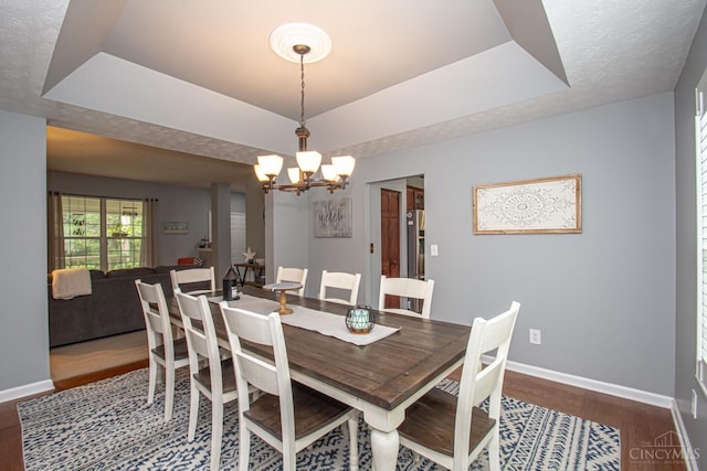 1887 Bantas Creek Rd, Washington Twp, OH 45320 - dining space with dark wood-style floors, a chandelier, and a tray ceiling
