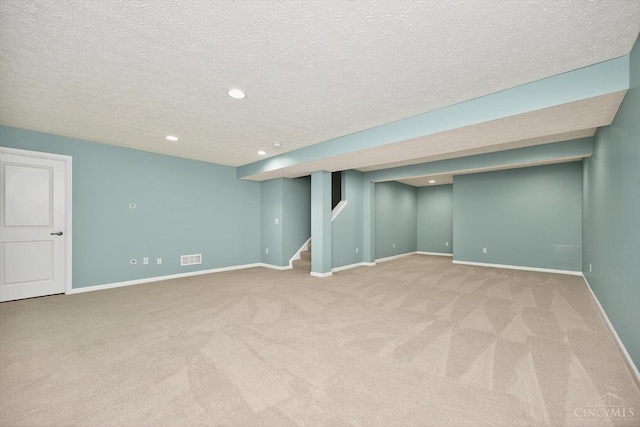9985 Scotch Pine Dr, Clearcreek Twp, OH 45066 - finished below grade area featuring carpet flooring, a textured ceiling, stairway, and recessed lighting