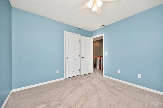9985 Scotch Pine Dr, Clearcreek Twp, OH 45066 - unfurnished bedroom featuring carpet floors, a ceiling fan, and a textured ceiling