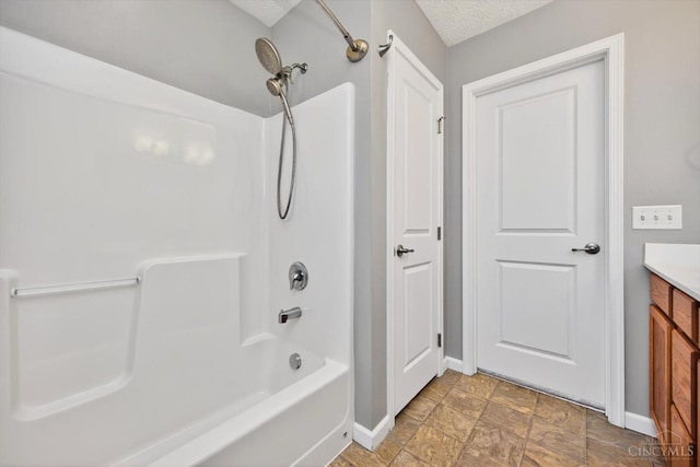 9985 Scotch Pine Dr, Clearcreek Twp, OH 45066 - bathroom featuring shower / bath combination, vanity, stone finish flooring, and a textured ceiling