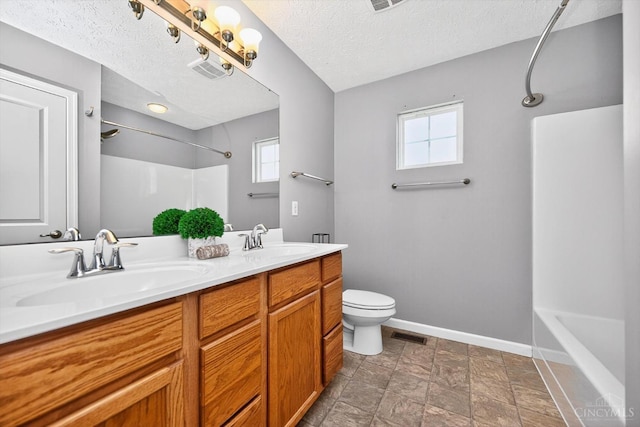 9985 Scotch Pine Dr, Clearcreek Twp, OH 45066 - bathroom featuring shower / tub combination, plenty of natural light, double vanity, a textured ceiling, and stone finish floors