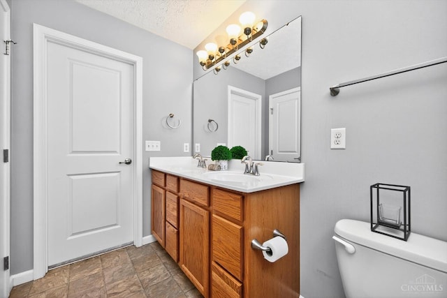 9985 Scotch Pine Dr, Clearcreek Twp, OH 45066 - full bathroom featuring double vanity, stone finish floors, and a textured ceiling