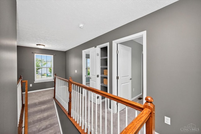 9985 Scotch Pine Dr, Clearcreek Twp, OH 45066 - hallway featuring an upstairs landing and a textured ceiling