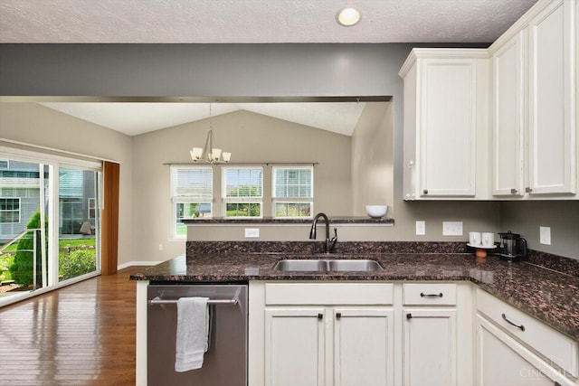 9985 Scotch Pine Dr, Clearcreek Twp, OH 45066 - kitchen featuring dishwasher, vaulted ceiling, white cabinets, wood finished floors, and a peninsula