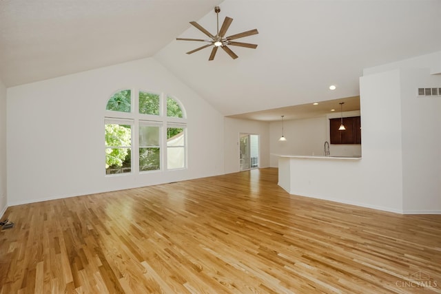 688 Humock Ct, Hamilton Twp, OH 45039 - unfurnished living room with light wood-type flooring, ceiling fan, and high vaulted ceiling
