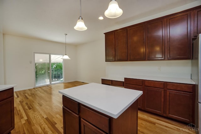 688 Humock Ct, Hamilton Twp, OH 45039 - kitchen featuring light countertops, light wood finished floors, pendant lighting, a kitchen island, and recessed lighting