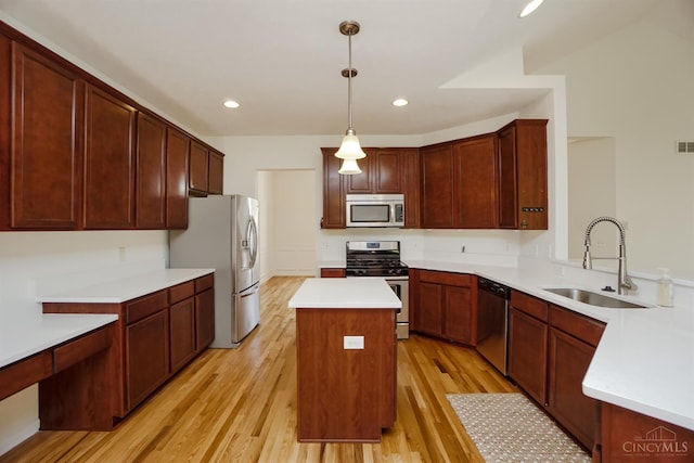 688 Humock Ct, Hamilton Twp, OH 45039 - kitchen with stainless steel appliances, light wood-style floors, a center island, light countertops, and recessed lighting
