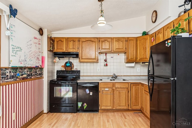 1167 Muirwood Ln, Union Twp, OH 45103 - kitchen featuring black appliances, under cabinet range hood, light wood-style flooring, light countertops, and lofted ceiling