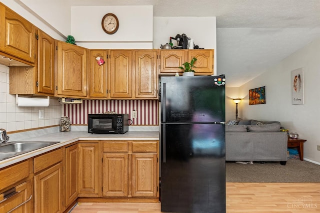 1167 Muirwood Ln, Union Twp, OH 45103 - kitchen featuring black appliances, light wood finished floors, backsplash, light countertops, and vaulted ceiling