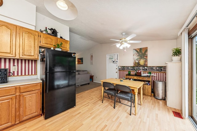 1167 Muirwood Ln, Union Twp, OH 45103 - kitchen featuring freestanding refrigerator, light wood-style flooring, ceiling fan, light countertops, and vaulted ceiling