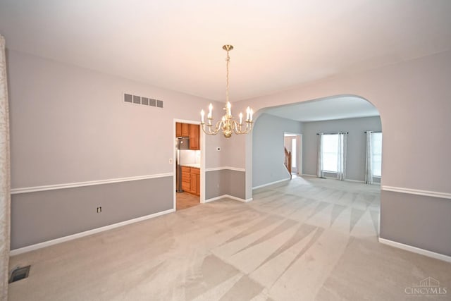 1001 Castlebay Dr, Pierce Twp, OH 45245 - empty room with light carpet, a chandelier, and arched walkways