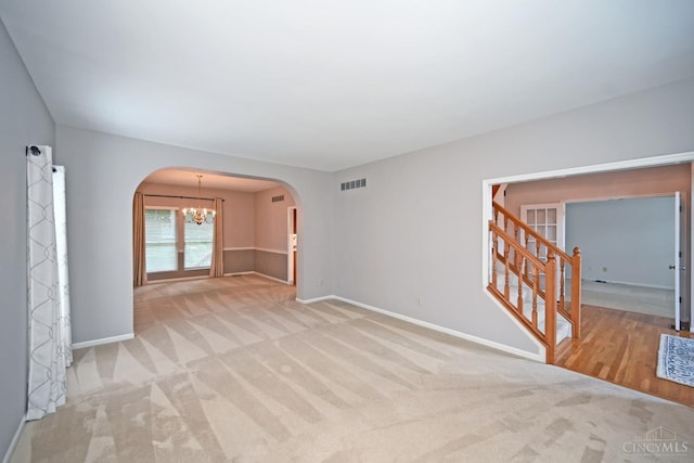 1001 Castlebay Dr, Pierce Twp, OH 45245 - carpeted spare room with arched walkways, a chandelier, and stairs