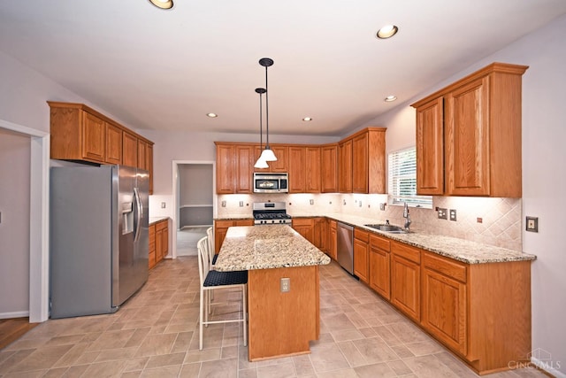 1001 Castlebay Dr, Pierce Twp, OH 45245 - kitchen with appliances with stainless steel finishes, a center island, light stone countertops, backsplash, and a kitchen breakfast bar