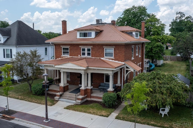 521 S Main St, Franklin, OH 45005 - traditional style home with a chimney, a porch, brick siding, and a metal roof