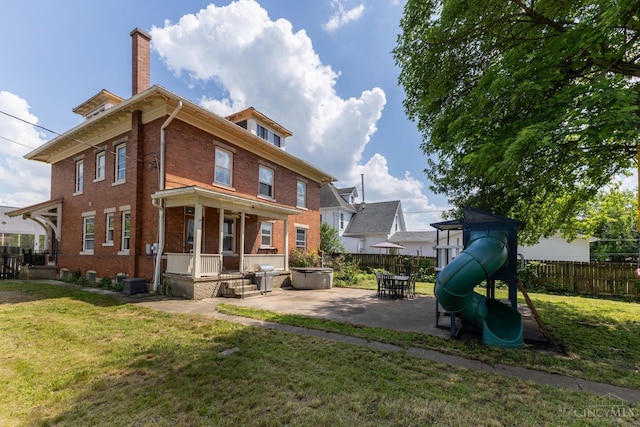 521 S Main St, Franklin, OH 45005 - rear view of property featuring brick siding, a playground, a chimney, and a patio area