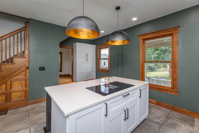 521 S Main St, Franklin, OH 45005 - kitchen with black electric stovetop, white cabinetry, healthy amount of natural light, and recessed lighting