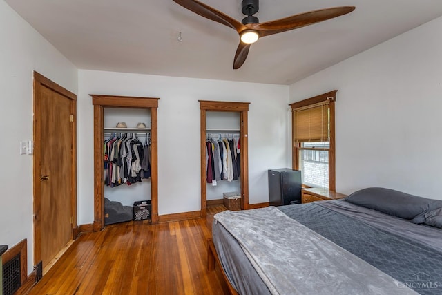 521 S Main St, Franklin, OH 45005 - bedroom with multiple closets, wood-type flooring, and ceiling fan