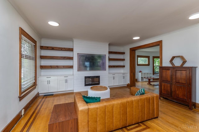 521 S Main St, Franklin, OH 45005 - living area with a fireplace, crown molding, light wood-style floors, and recessed lighting