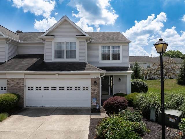 3649 Pebble Creek Ct, Mason, OH 45040 - traditional home featuring concrete driveway, a garage, a shingled roof, and brick siding