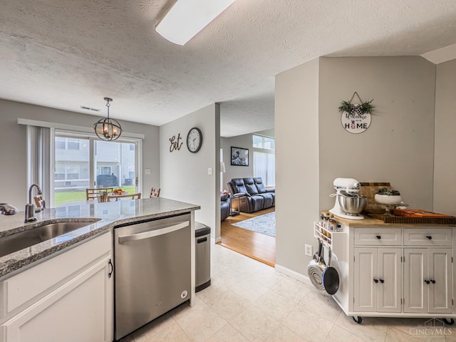 3649 Pebble Creek Ct, Mason, OH 45040 - kitchen with dishwasher, a chandelier, plenty of natural light, light stone countertops, and a textured ceiling