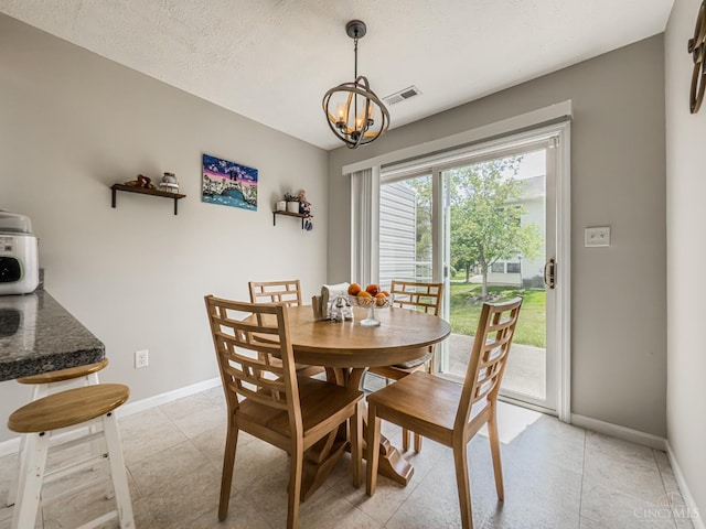 3649 Pebble Creek Ct, Mason, OH 45040 - dining room featuring a chandelier, a textured ceiling, and light tile patterned floors
