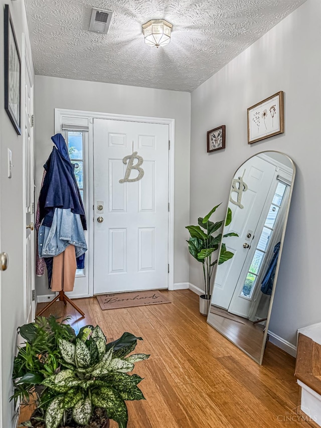 3649 Pebble Creek Ct, Mason, OH 45040 - entrance foyer featuring wood finished floors and a textured ceiling