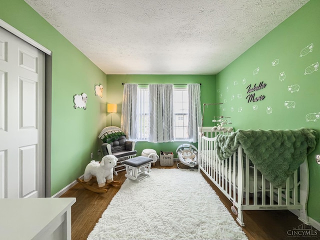 3649 Pebble Creek Ct, Mason, OH 45040 - bedroom featuring a textured ceiling, wood finished floors, and a crib