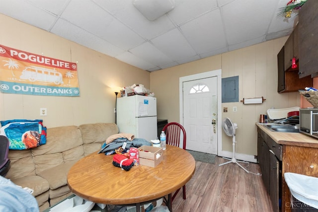 201 W Cherry St, Georgetown, OH 45121 - living area with a paneled ceiling, wood finished floors, and electric panel