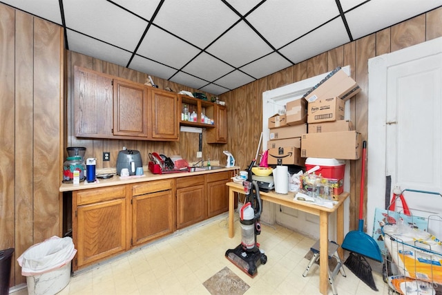 201 W Cherry St, Georgetown, OH 45121 - kitchen with light countertops, light floors, wood walls, open shelves, and brown cabinets