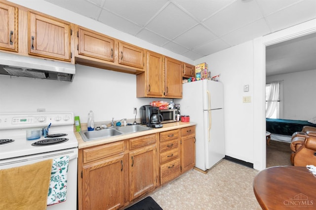 201 W Cherry St, Georgetown, OH 45121 - kitchen with white appliances, under cabinet range hood, a paneled ceiling, light countertops, and light floors