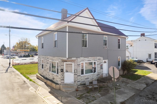 201 W Cherry St, Georgetown, OH 45121 - view of front of property featuring stone siding, a chimney, and a metal roof