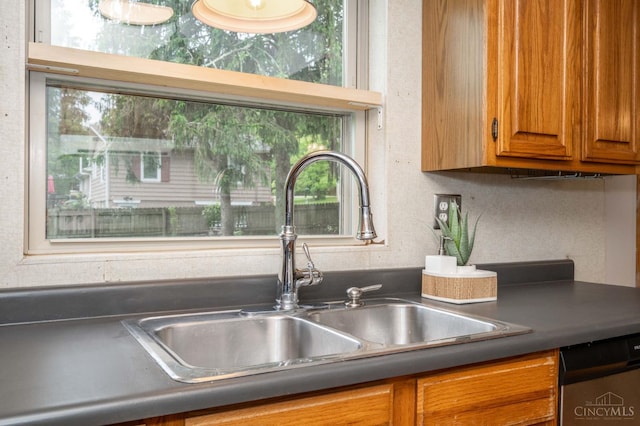 8385 Bridle Rd, Anderson Twp, OH 45244 - kitchen featuring dishwasher, brown cabinets, and dark countertops