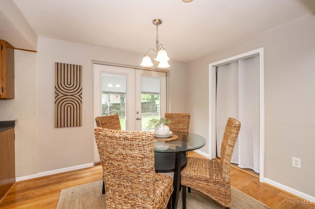 8385 Bridle Rd, Anderson Twp, OH 45244 - dining room with light wood-style flooring and a chandelier