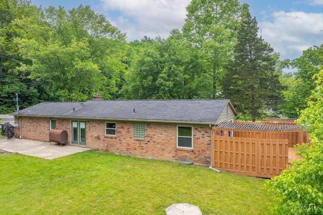 8385 Bridle Rd, Anderson Twp, OH 45244 - rear view of property with a patio, brick siding, a chimney, oil tank, and a shingled roof