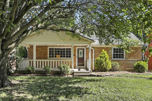 1006 Harbury Dr, Springfield Twp, OH 45224 - view of front of property with brick siding, a front lawn, and a porch