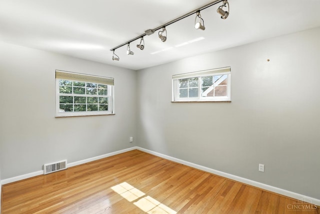 1006 Harbury Dr, Springfield Twp, OH 45224 - unfurnished room featuring rail lighting and wood finished floors