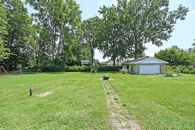 3638 El Rego Dr, Pierce Twp, OH 45102 - view of yard with a detached garage, an outdoor structure, and a fire pit