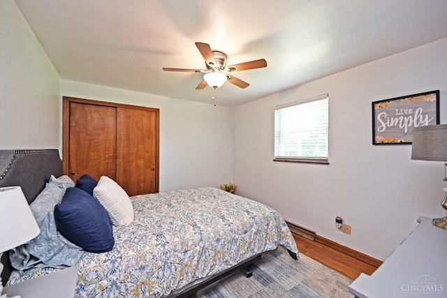 3638 El Rego Dr, Pierce Twp, OH 45102 - bedroom with wood finished floors, a closet, ceiling fan, and a baseboard heating unit