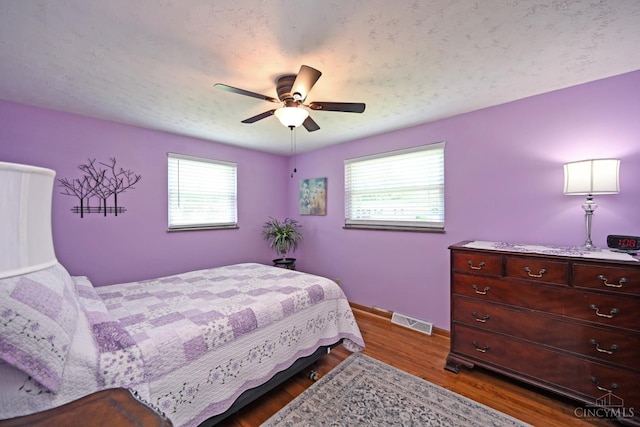 3638 El Rego Dr, Pierce Twp, OH 45102 - bedroom featuring multiple windows, dark wood-type flooring, and a ceiling fan