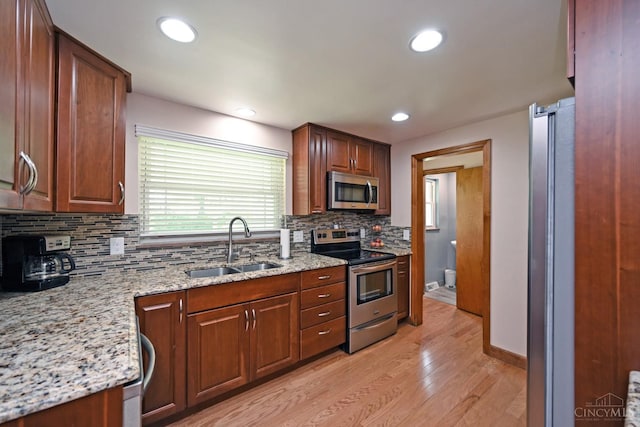 3638 El Rego Dr, Pierce Twp, OH 45102 - kitchen featuring stainless steel appliances, light wood-style flooring, backsplash, light stone counters, and recessed lighting