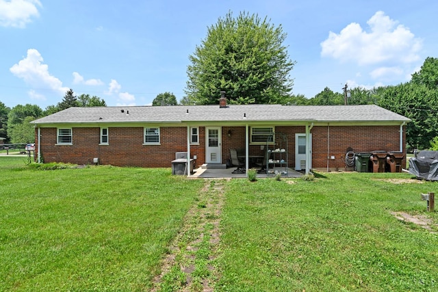 3638 El Rego Dr, Pierce Twp, OH 45102 - back of property with a patio, brick siding, and a yard