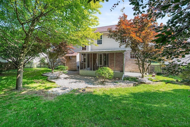 125 Sackett Dr, Monroe, OH 45050 - back of house featuring a sunroom, a fenced backyard, and brick siding