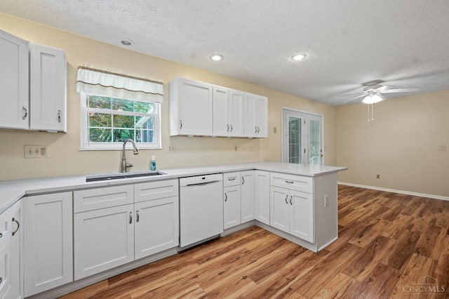 125 Sackett Dr, Monroe, OH 45050 - kitchen featuring white dishwasher, a textured ceiling, a peninsula, light wood-style floors, and ceiling fan