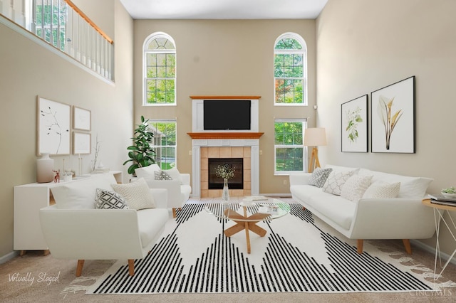 125 Sackett Dr, Monroe, OH 45050 - living room featuring a high ceiling, a tile fireplace, and carpet flooring