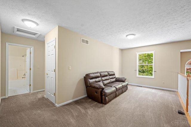 125 Sackett Dr, Monroe, OH 45050 - living area with attic access, carpet, and a textured ceiling
